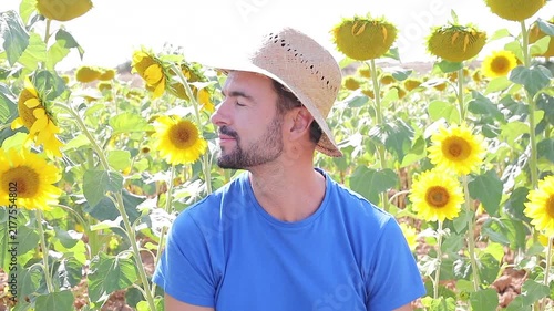 Cute farmer in sunflower field