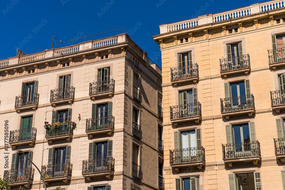 Fototapeta premium Building Facade With French Balconies and Wooden Shutters in Barcelona City in Spain