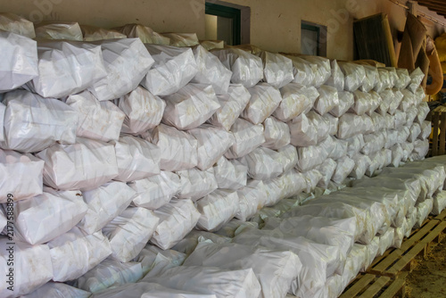 Warsaw, Poland,May 15, 2026. Wide shot of a clean warehouse interior filled with stacked rows of white bags in Warsaw. High quality photograph