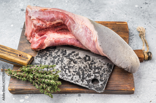 Принти на полотні Raw beef tongue on wooden board with cleaver and fresh thyme