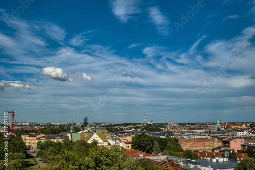 Krakow cityscape panorama with historic rooftops under blue sky