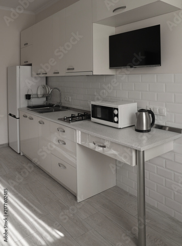 Konstfotografi Modern kitchen living area cabinets appliances grey countertops, light wood floo