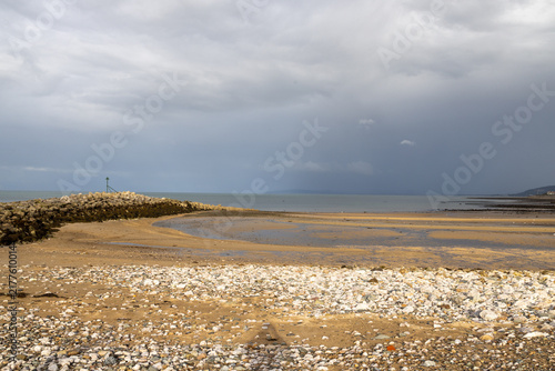 Obraz na plátne Rocky and sandy shoreline at Penrhyn Bay North Wales during low tide with calm s
