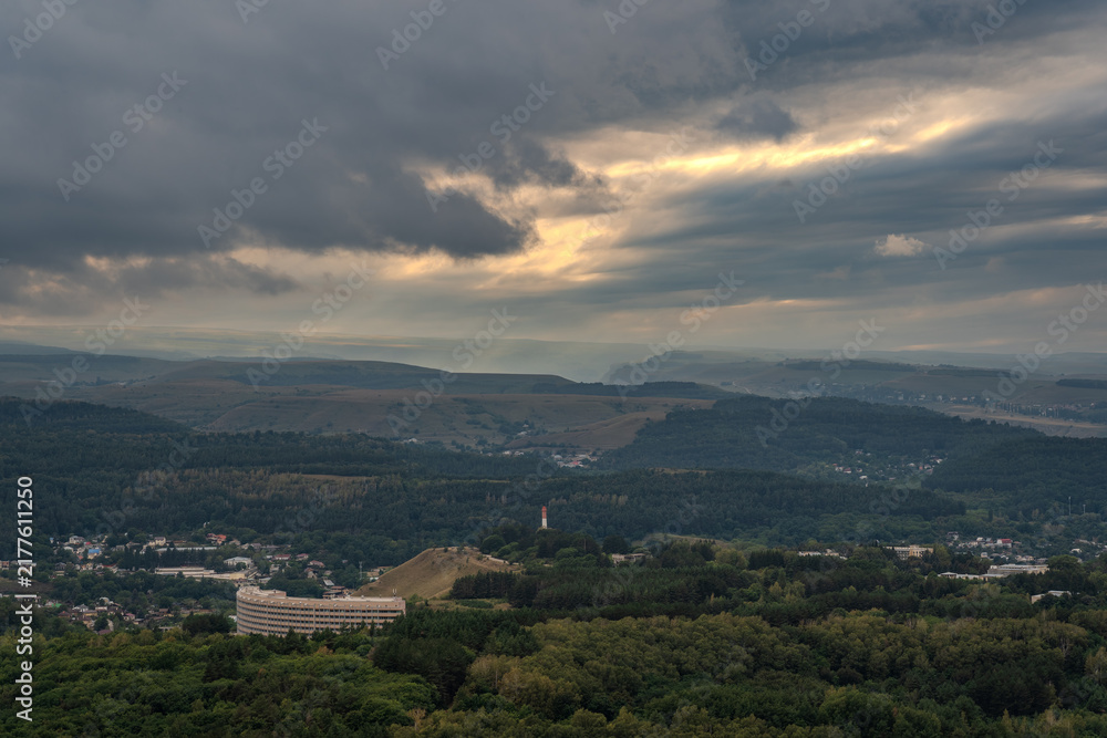 Fototapeta premium View of the mountains and Kislovodsk from the observation decks of the Kislovodsk Park. Evening sunset over the mountains of Kislovodsk.