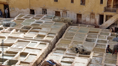 Принти на полотні Vats of chemicals to tan and soften leather in the courtyard of the Chouara Tann