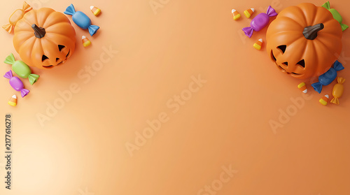 Two jack o lantern pumpkins with colorful candy on an orange background for Halloween celebration