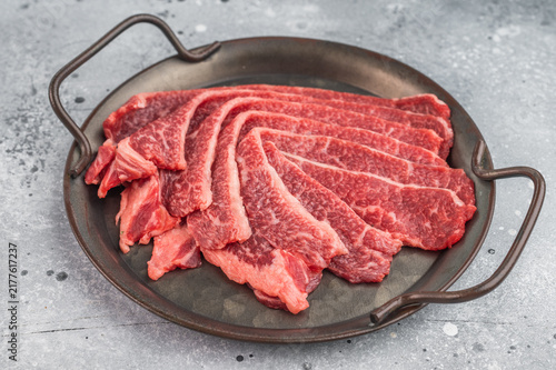 Konstfotografi Fresh raw beef bacon slices on dish, marbled angus meat ingredient on light back