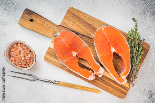 Photography Raw chum salmon steaks also known as pink salmon on wooden board with thyme and