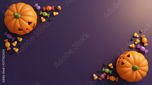 Halloween pumpkins and colorful candies on a dark purple background for a holiday greeting card