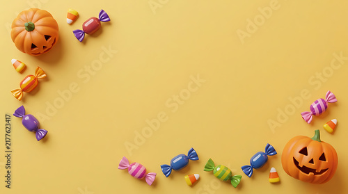 Cute Halloween pumpkins and colorful wrapped candies arranged in a border on a yellow background with copy space for text