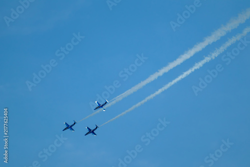 Air stunts by three Aero L-29 Delfin jet planes with contrails in scenic sky on airshow