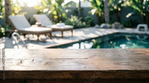 Wooden Table Top with Pool and Lounge Chairs in Background for Web Design