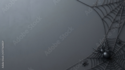 Black spider sitting on a detailed cobweb on a dark grey background for halloween