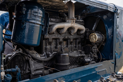 Canvastavla Under-the-hood view of vintage crawler tractor diesel engine showing exhaust manifold, air filter, radiator fan, and mechanical components