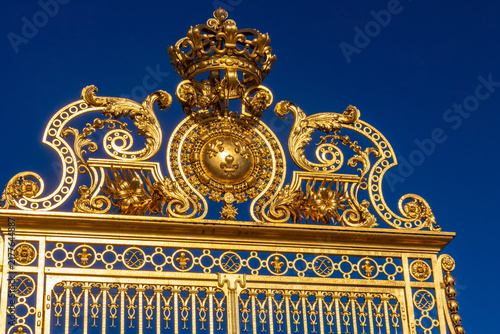 Close-up of the golden gate with a crown on top at the Palace of Versailles, France
