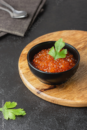 Red salmon caviar with parsley in a bowl