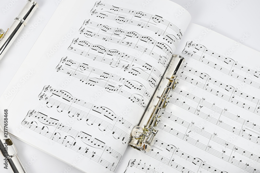 Fototapeta premium Arrangement of a sheet music and parts of a transverse flute