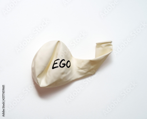 Canvas Print Deflated white balloon labeled EGO symbolizing humbled pride and losing self-imp
