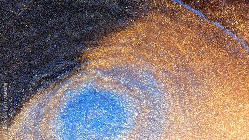 Fotografie Mixing alcohol ink in a macro shot showing vibrant colors and textures