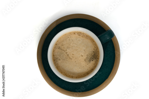 Obraz na plátne Top-down view of a cup of coffee with rich crema on a teal and brown saucer on a