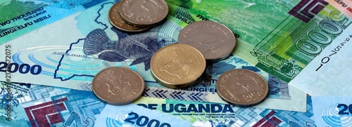 Fotografie Ugandan shilling money banknotes and coins on table