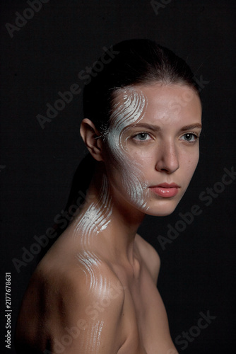 Konstfotografi A portrait of a nude young woman with white artistic makeup on her face and neck