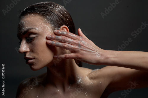 Konstfotografi A portrait of a nude young woman with white artistic makeup on her face and neck