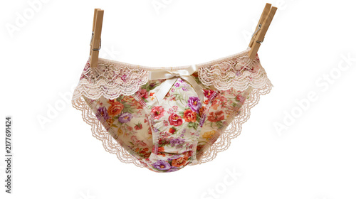Quadro su tela Isolated delicate floral print lace women's underwear hanging on clothespins for laundry