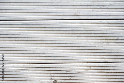 Obraz na plátne Close up view of white painted wooden boards with manmade horizontal grooved patterns forming a textured abstract background