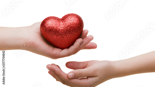 Fotografía Isolated human hands giving and receiving a sparkling red heart showing love and
