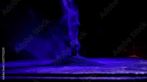 Vibrant purple ink explosion bursts from a dark surface in an abstract motion shot creating a dynamic and captivating visual effect perfect for creative projects