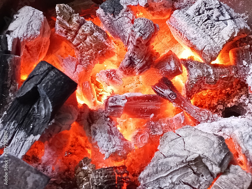 Obraz na plátně close up of burning wood charcoal with glowing red hot embers for grilling, ener