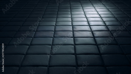 Dark textured surface with dramatic spotlight and grid pattern