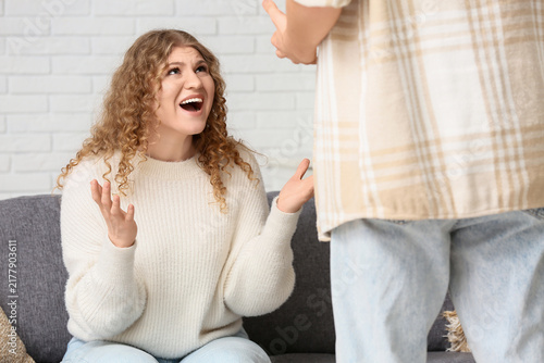 Fotografie Angry young couple squabbling at home