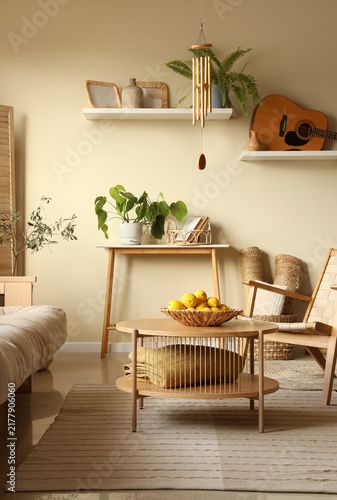Canvastavla Interior of light living room with wind chime, shelves and table