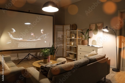 Obraz na płótnie Home cinema and entertainment, people watching a movie on a projector screen in