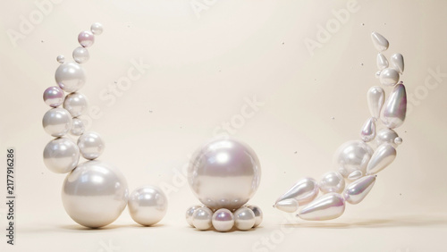 Floating iridescent pearl spheres and teardrop shapes on soft cream colored background