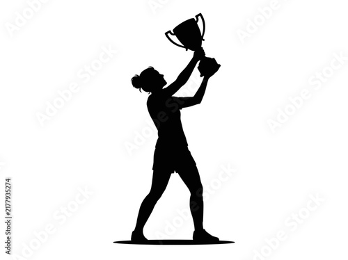 Silhouette of a triumphant female athlete holding up a winning trophy cup in victory and success