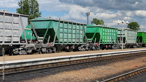 Foto Freight train wagons standing on railway tracks at a railway station