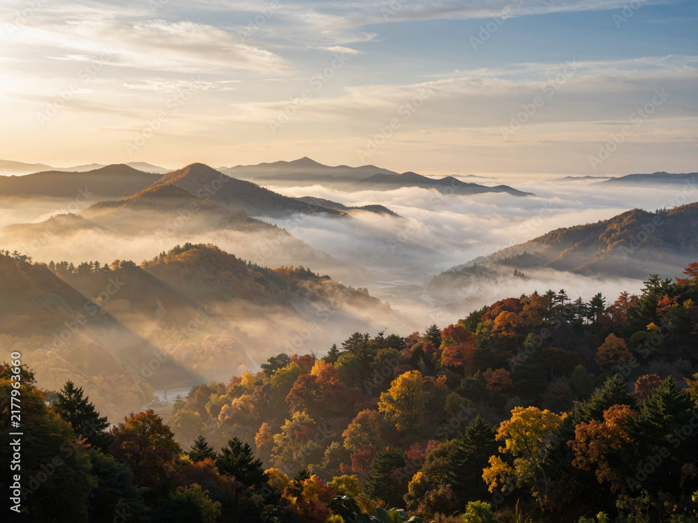 Obraz premium Autumn mountain range with morning fog and sunlight