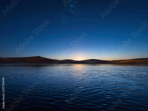 Sunset over a desert lake with sand dunes and a starry sky