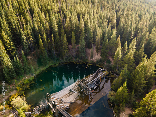 Old dredge surrounded by a forest