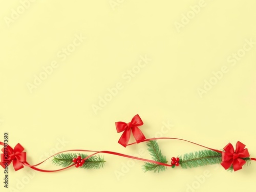 Christmas border with pine, berries, red bows on light yellow