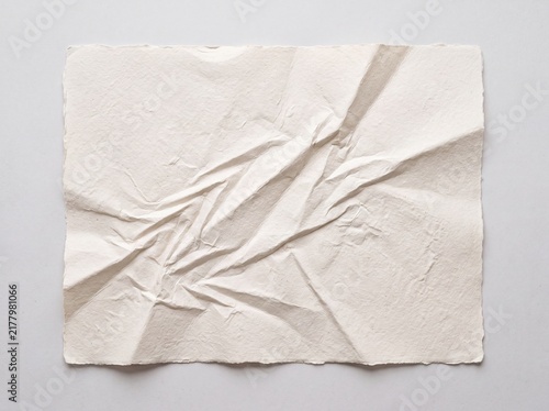 Crumpled white handmade paper texture, wrinkled vintage parchment sheet, textured recycled paper background for stationery mockups