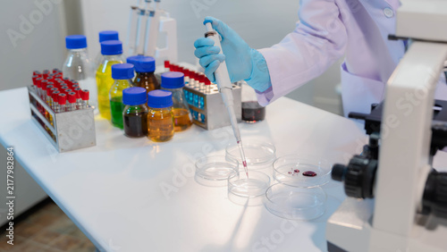 Konstfotografi Scientist holding beaker with yellow chemical liquid in chemistry laboratory