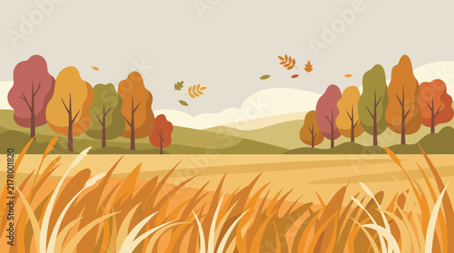 Beautiful autumn landscape with colorful forest trees and yellow grass field under a cloudy sky