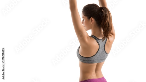 A person stretching both arms over the head, wearing sportswear. Isolated on white background.