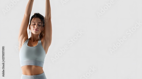 A person stretching both arms over the head, wearing sportswear. Isolated on white background.