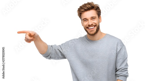 A person smiling and pointing sideways, isolated on white background.