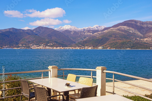 Beautiful winter Mediterranean landscape. Montenegro, Bay of Kotor, Tivat.  Small outdoor cafe on embankment